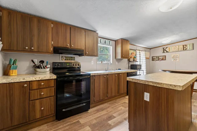 a kitchen with a stove top oven sink and cabinets