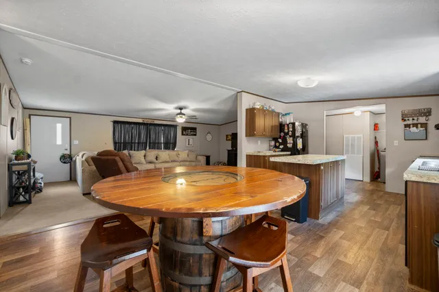 a dining room with furniture and wooden floor