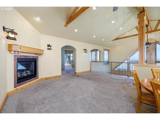 a view of empty room with wooden floor and fireplace