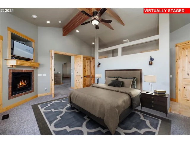 a bedroom with a bed and a fireplace