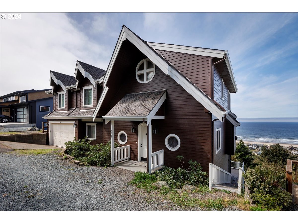 367 South Longview Loop Rockaway Beach, OR 97136 - Photo 2 of 43 a front view of a house with garden