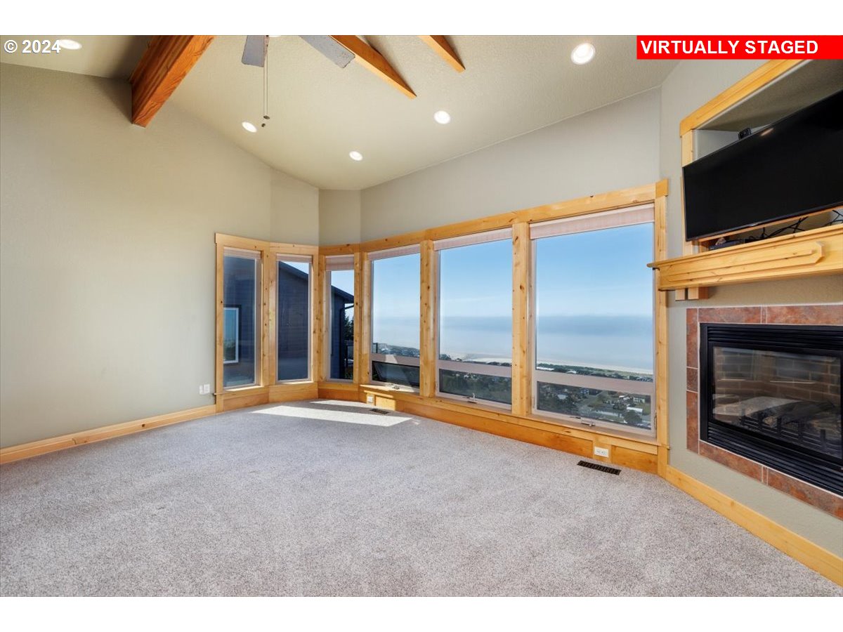 367 South Longview Loop Rockaway Beach, OR 97136 - Photo 21 of 43 a view of an empty room with a fireplace and a flat screen tv