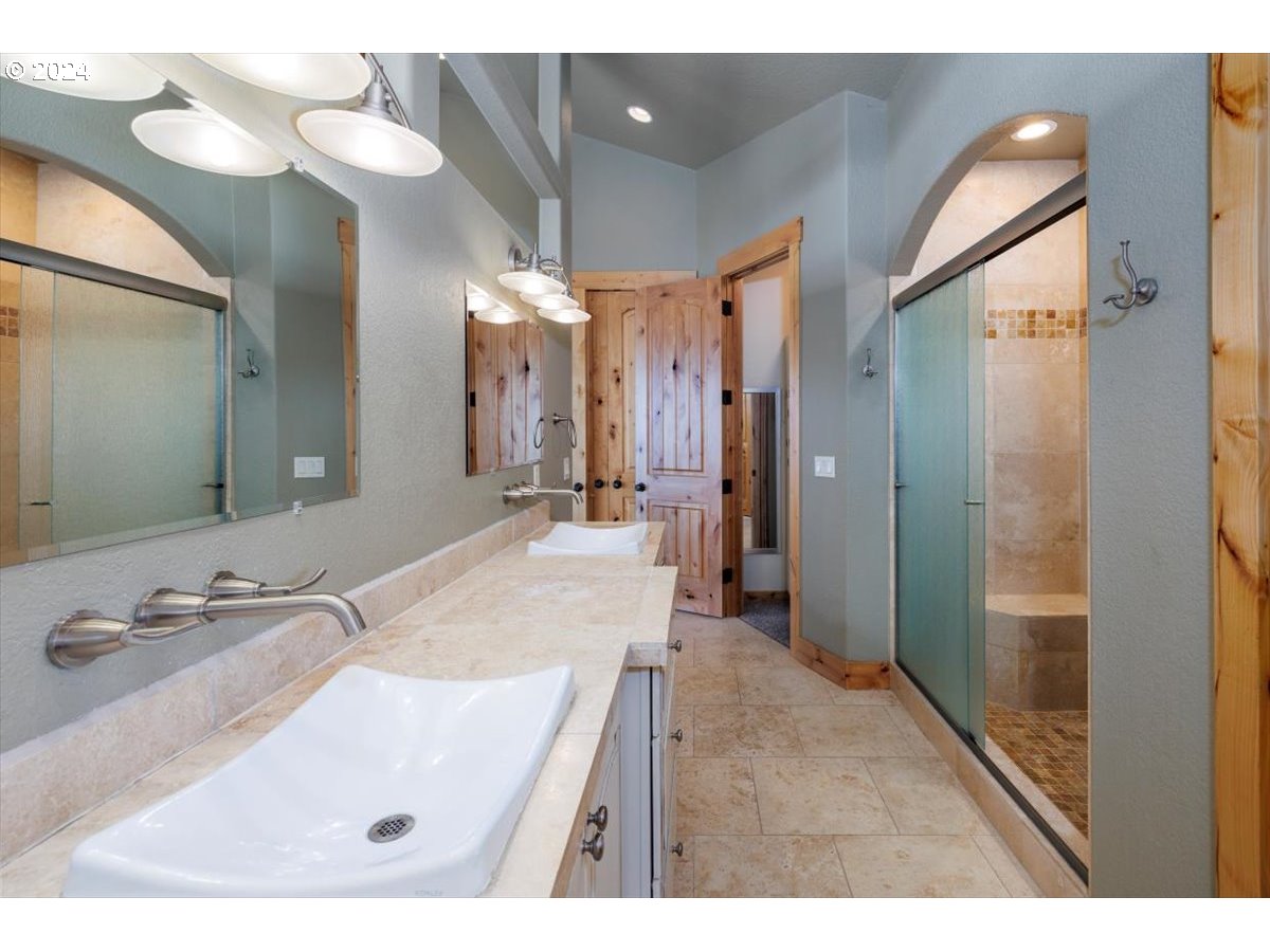 367 South Longview Loop Rockaway Beach, OR 97136 - Photo 22 of 43 a bathroom with a sink tub shower and a mirror