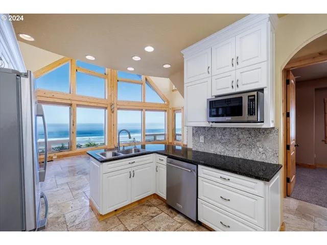 a kitchen with stainless steel appliances kitchen island granite countertop a sink and cabinets