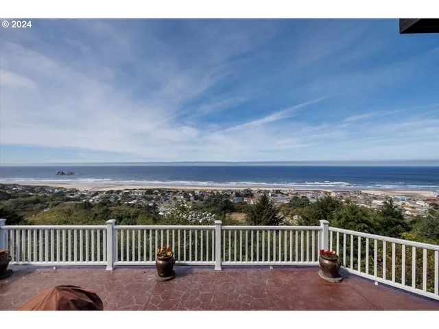a view of balcony with wooden floor & fence