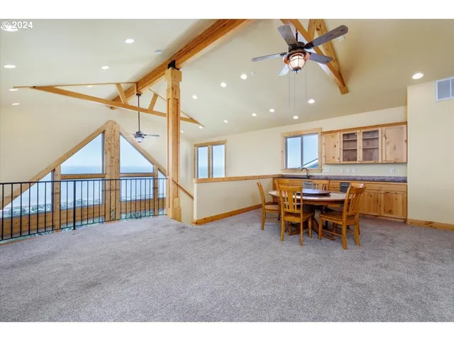 a view of a livingroom with furniture and a window