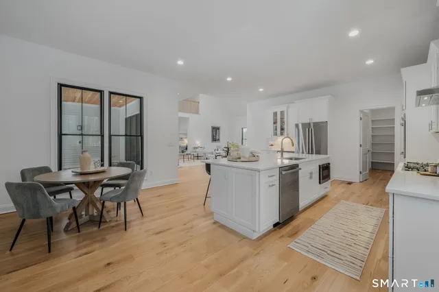 a living room with furniture a wooden floor and a sink