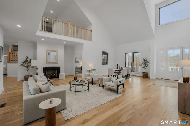 a living room with furniture a fireplace and a table