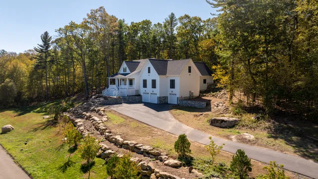 a view of a house with a yard covered in snow