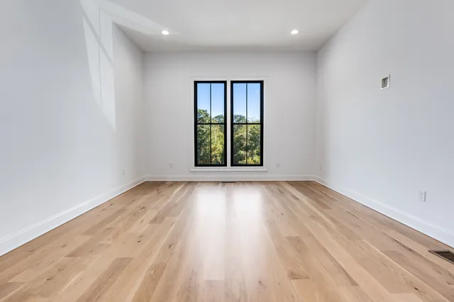 wooden floor in an empty room with a window