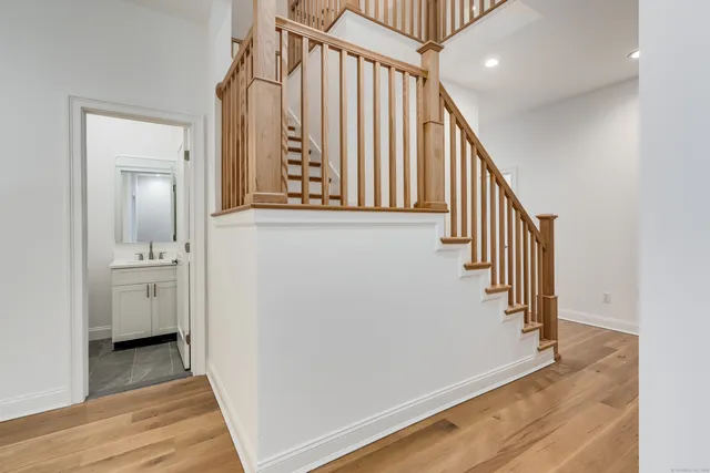 a view of a hallway with wooden floor and entryway