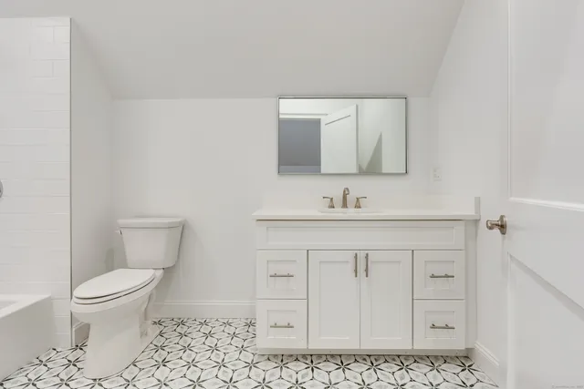 a bathroom with a sink toilet and vanity