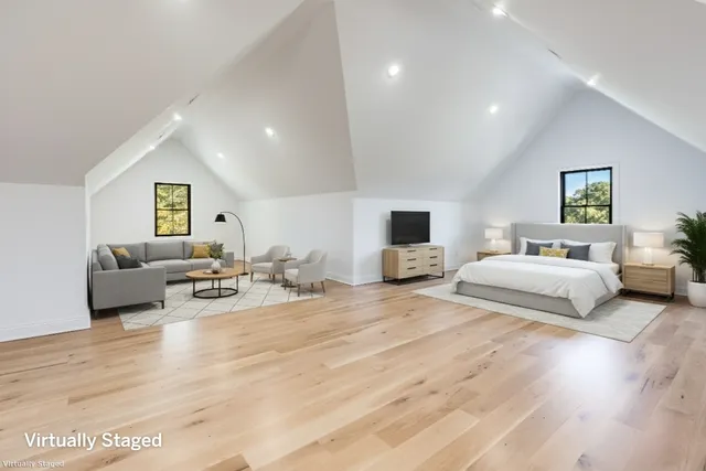 a spacious bedroom with a bed and a couch