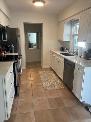 a kitchen with a sink a stove and refrigerator