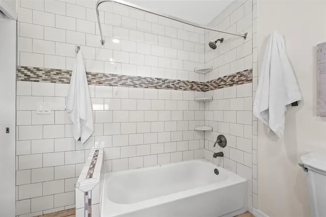 a bathroom with a bathtub and shower