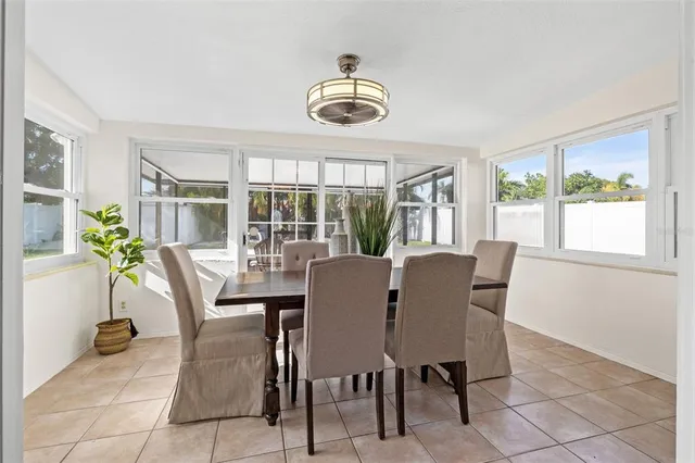 a dining room with furniture window and outside view