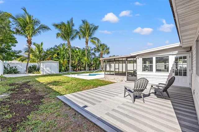 a view of a house with backyard and sitting area