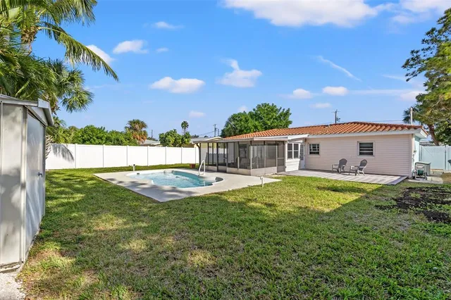 a view of a house with pool and a yard