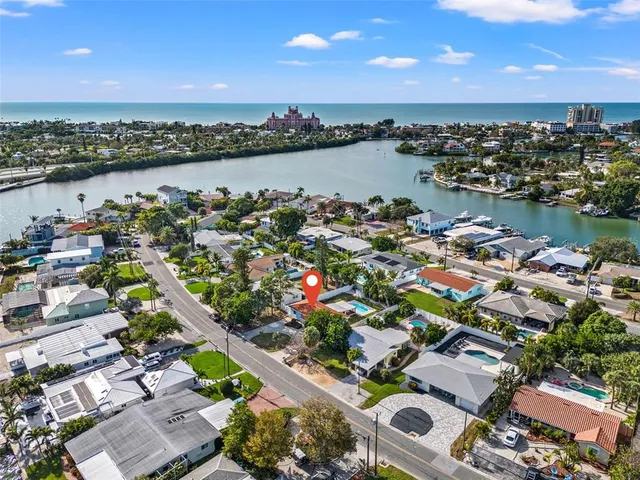 an aerial view of a house with a yard basket ball court and outdoor seating