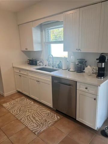 a kitchen with a sink cabinets and window