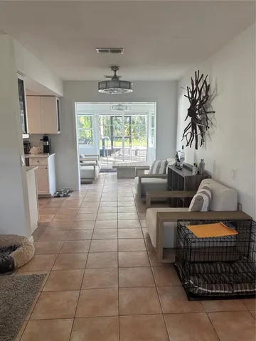 a living room with furniture a window and a chandelier