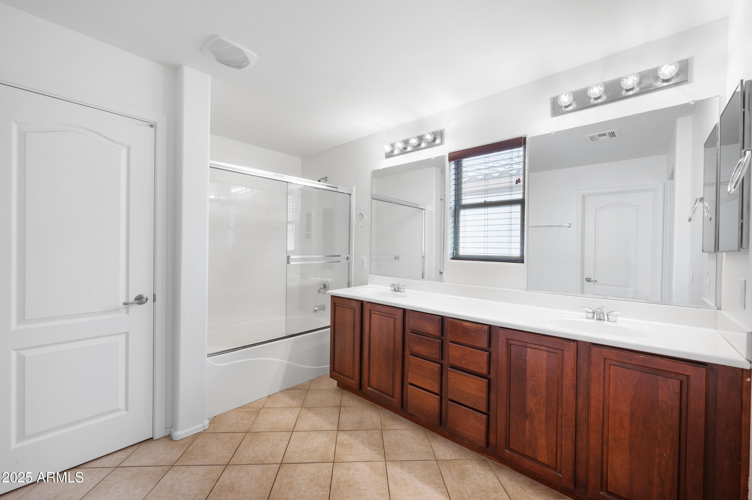 2646 East Megan Street Gilbert, AZ 85295 - Photo 18 of 40 a bathroom with a double vanity sink mirror and shower