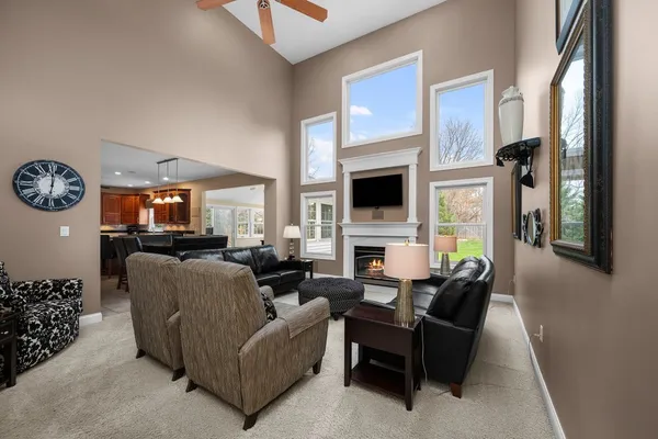 a living room with furniture a fireplace and a flat screen tv