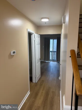 a view of hallway with wooden floor
