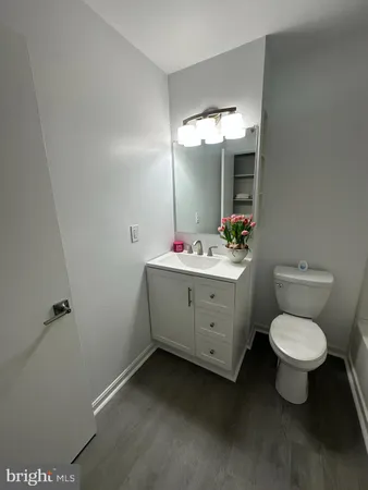 a bathroom with a sink toilet mirror and shower
