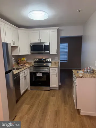 a kitchen with a stove a sink and a microwave