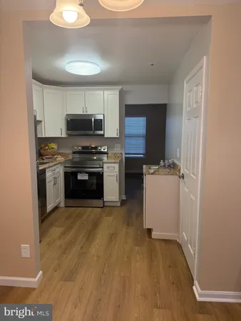 a kitchen with a sink and a stove top oven