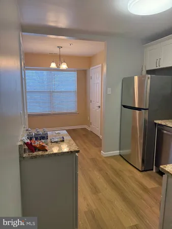 a kitchen with a refrigerator and a stove