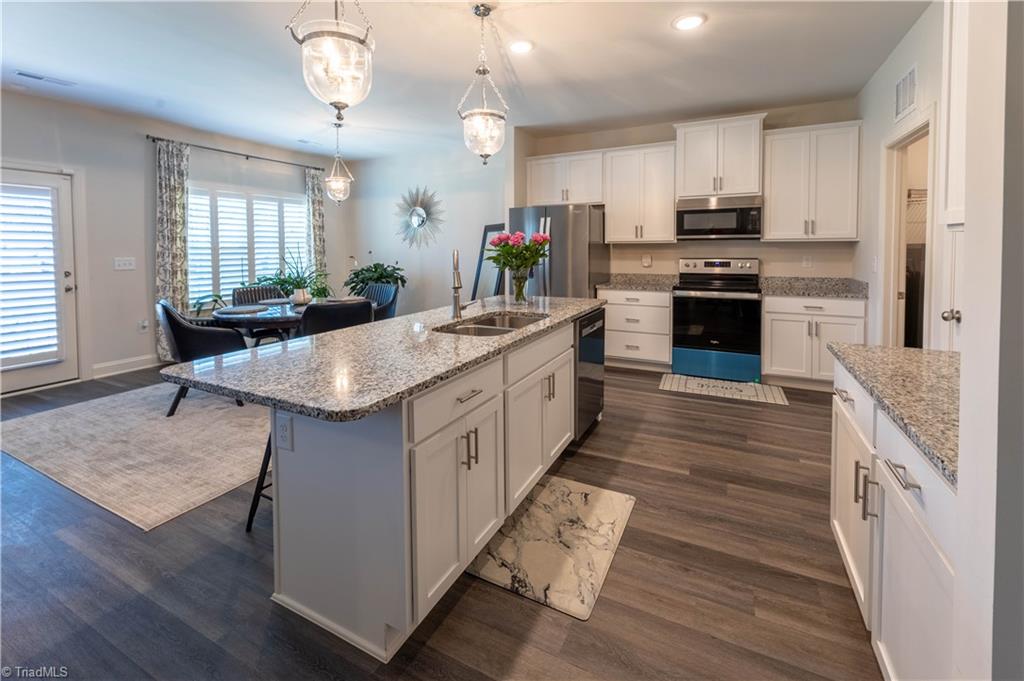 Beautiful open kitchen with stainless steel appliances and granite countertops, newly added chandeliers as well.