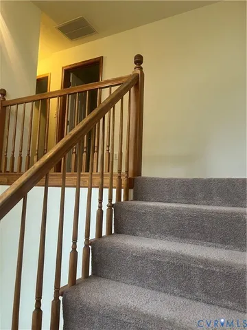 a view of staircase with lots of wooden floor and a window