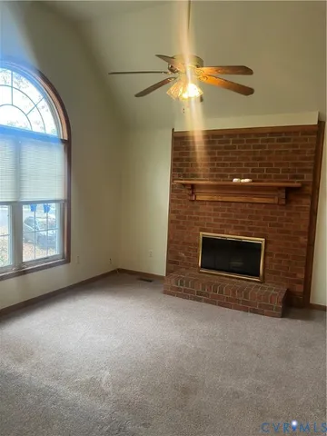 an empty room with a fireplace and window