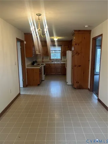 a view of a kitchen with furniture and a refrigerator