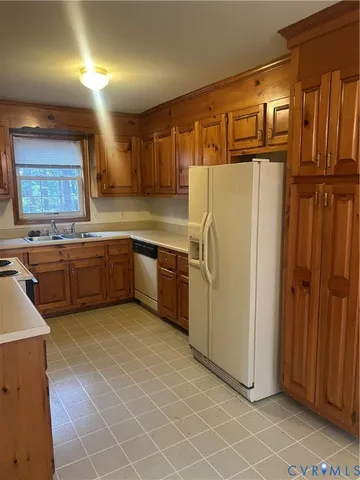 a kitchen with stainless steel appliances a refrigerator and a sink