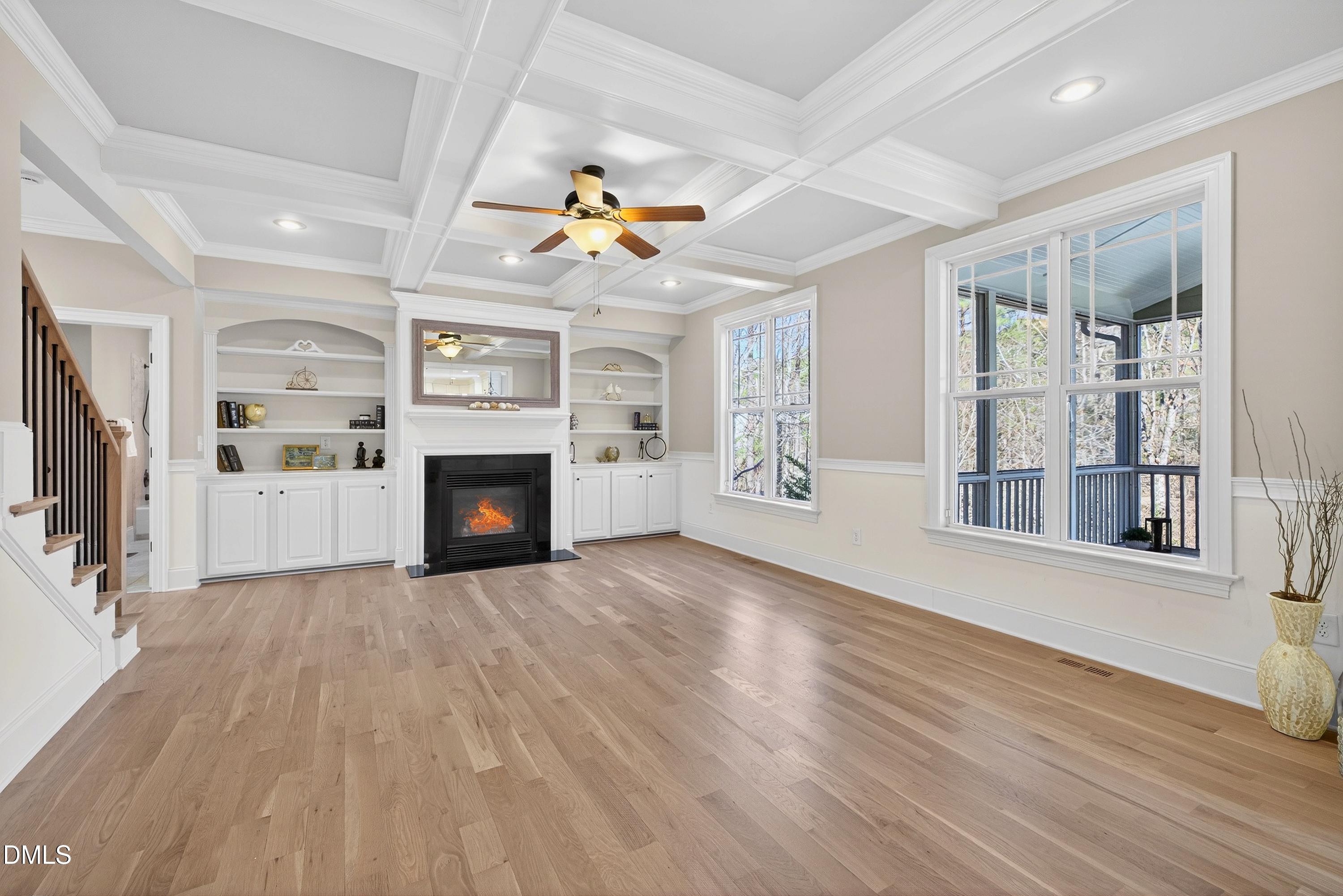 307 Ashdown Forest Lane Cary, NC 27519 - Photo 15 of 91 a view of a livingroom with a fireplace a ceiling fan and windows