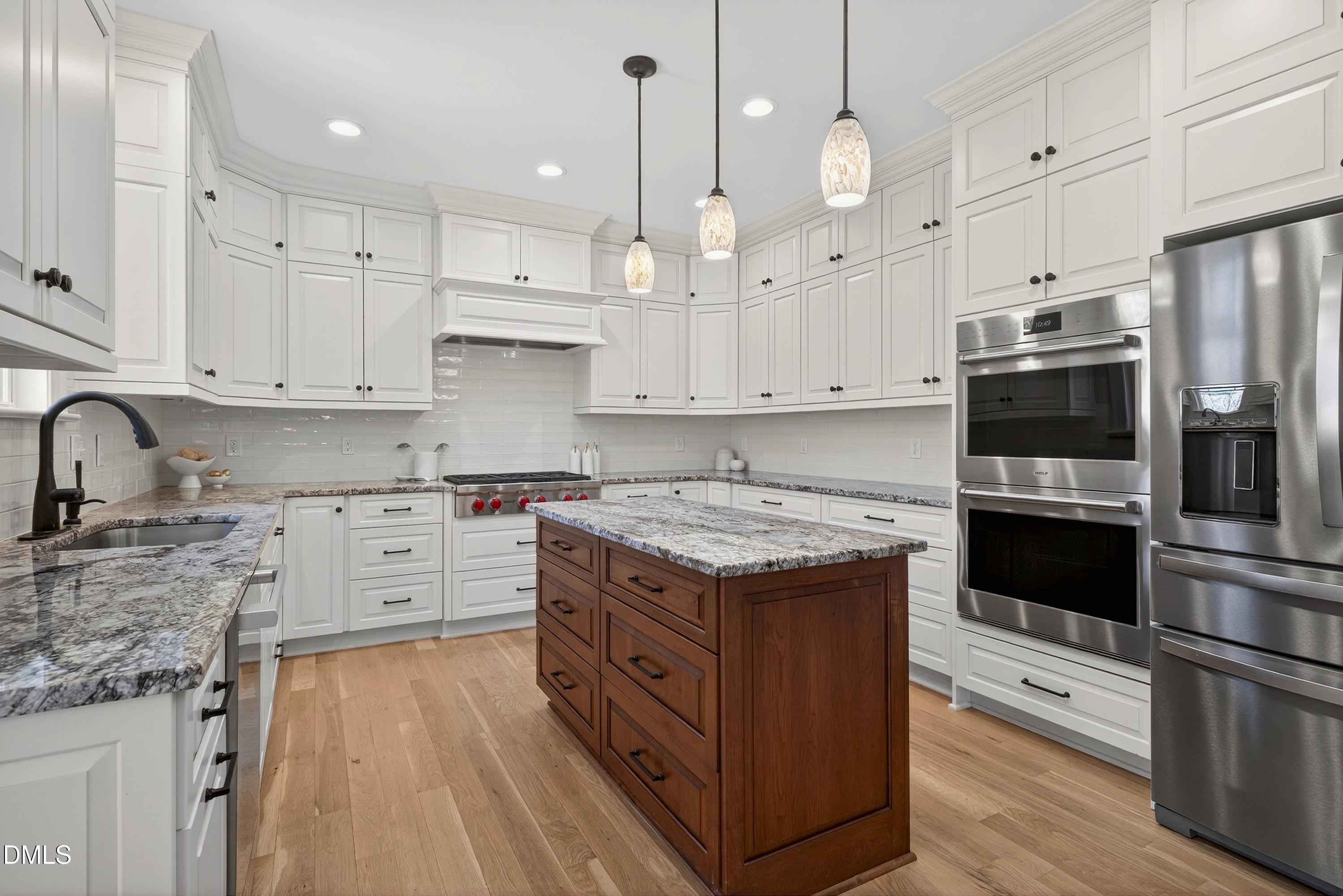 307 Ashdown Forest Lane Cary, NC 27519 - Photo 22 of 91 a kitchen with stainless steel appliances granite countertop a stove oven and a white cabinets