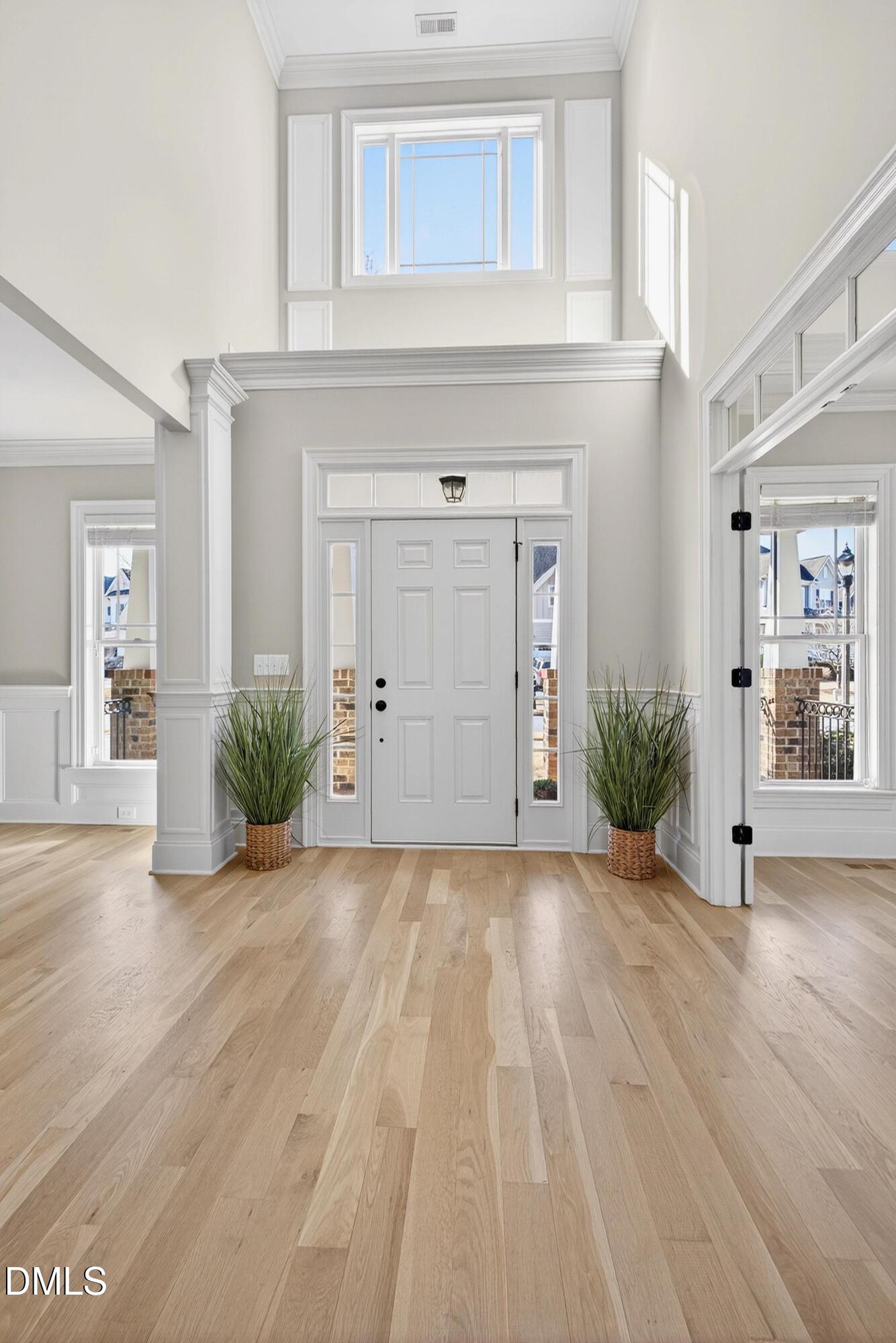 307 Ashdown Forest Lane Cary, NC 27519 - Photo 5 of 91 a view of a hallway with wooden floor and a living room