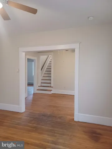 a view of a room with wooden floor