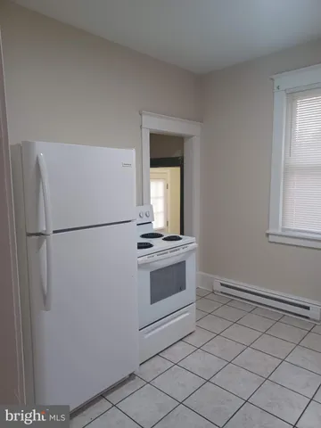 a kitchen with a refrigerator and a stove