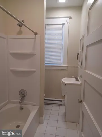a bathroom with a bathtub sink and toilet