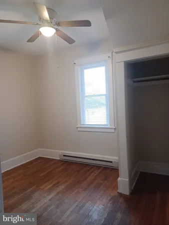 a view of a room with wooden floor and windows