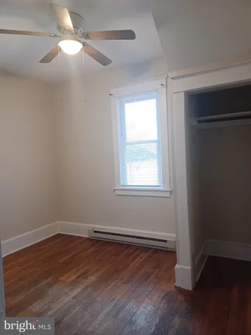 a view of a room with wooden floor and windows