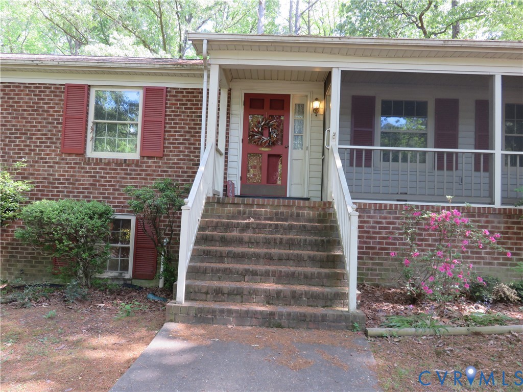 8379 Quailfield Road Mechanicsville, VA 23116 - Photo 13 of 56 a front view of a house with a garden