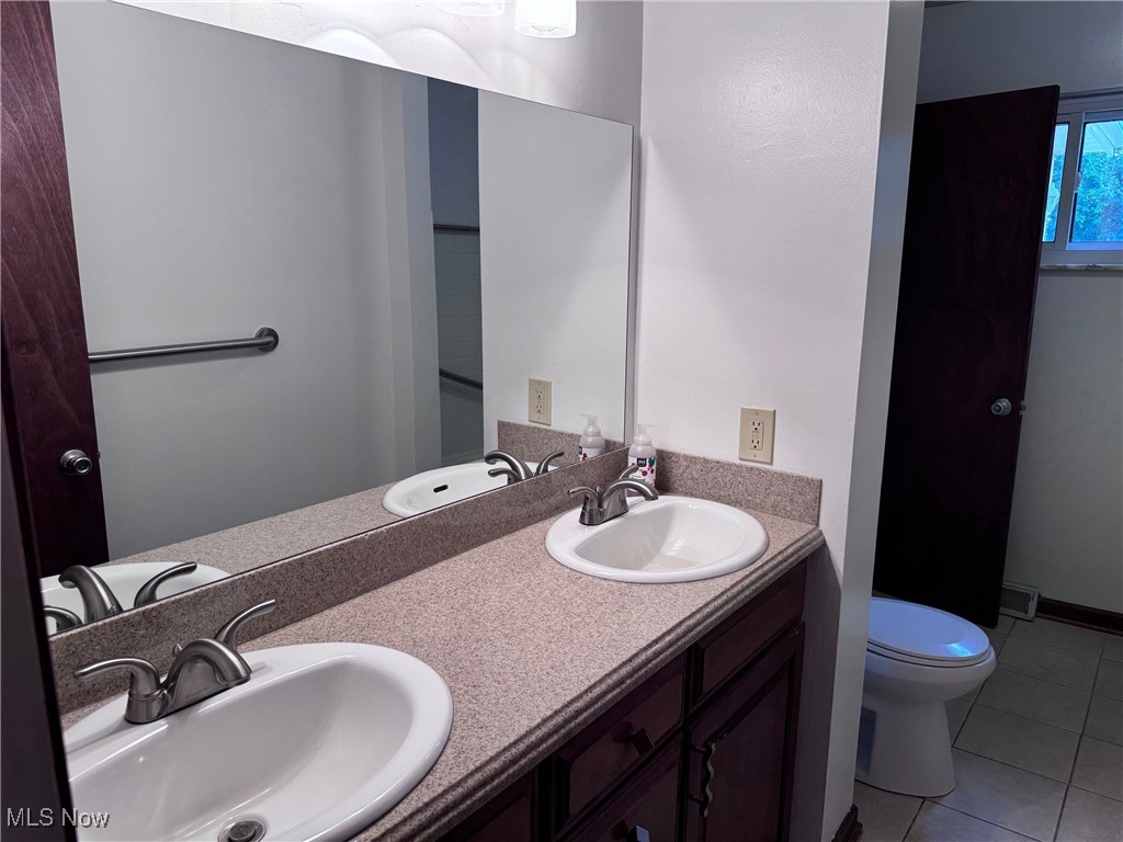 1719 Beryl Road Akron, OH 44312 - Photo 13 of 27 Bathroom with tile patterned flooring, toilet, and vanity