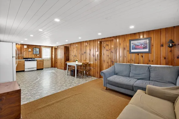 a large kitchen with granite countertop lots of white stainless steel appliances cabinets and a sink