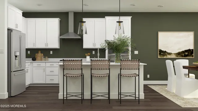 a kitchen with appliances cabinets and chair