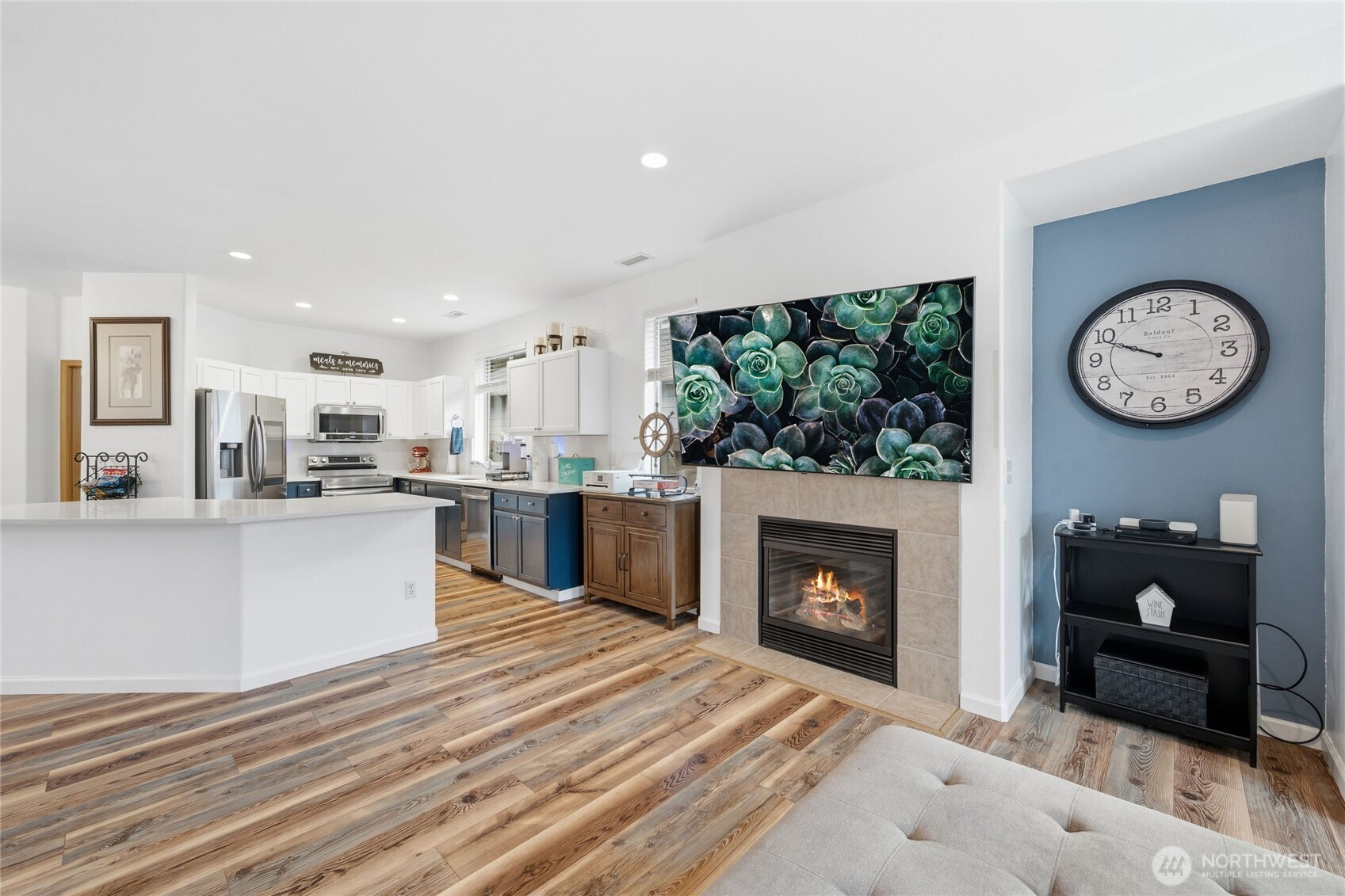 8218 Bainbridge Loop Northeast Lacey, WA 98516 - Photo 19 of 40 a large white kitchen with a fireplace and a large window